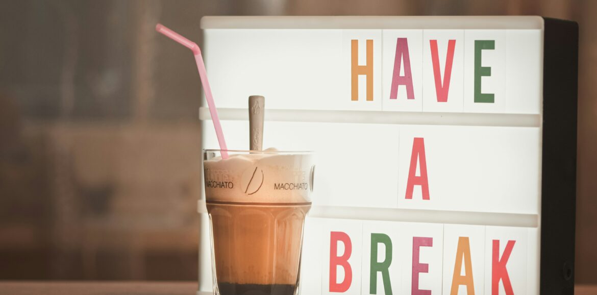 Pausenschild mit Latte Macchiato Becher davor